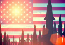 Missiles silhouetted against American flag background with sunset