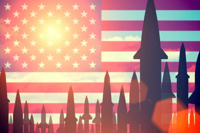 shutterstock_405618091.jpg Missiles silhouetted against American flag background with sunset