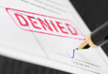 Denied stamp and pen signing document