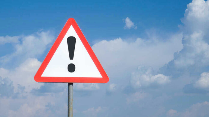 shutterstock_1783779719.jpg Triangle warning sign with exclamation mark against sky