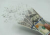 Hundred dollar bills disintegrating in hand