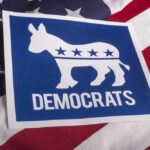 Democratic Party donkey logo on American flag background