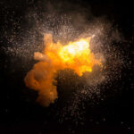 Bright explosion against a dark background with sparks