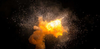 Bright explosion against a dark background with sparks