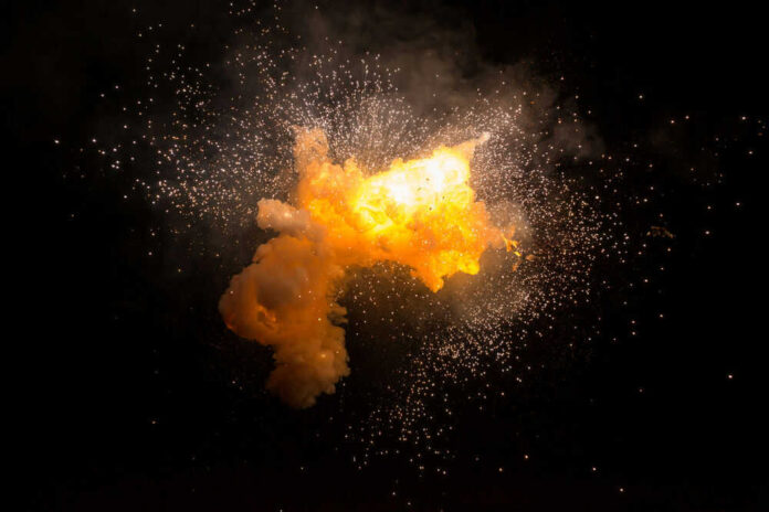 Bright explosion against a dark background with sparks