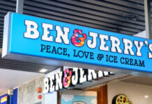 Signage for Ben and Jerry's ice cream shop displaying the slogan Peace, Love and Ice Cream