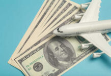 A model airplane placed on top of dollar bills