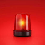 Red emergency light on solid red background.