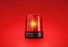 Red emergency light on solid red background.