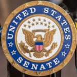 United States Senate seal with microphones in front