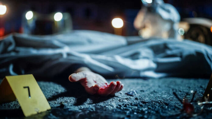 shutterstock_2230645915.jpg Crime scene with covered body and hand exposed