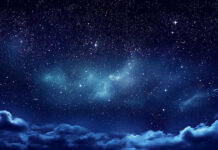 Starry night sky with clouds below