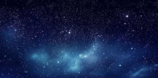 Starry night sky with clouds below
