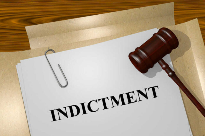 Gavel on a white paper with the word indictment on it