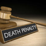 Gavel beside death penalty sign on desk