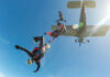 Skydivers jumping from an airplane in midair