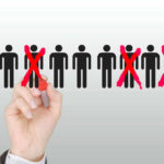 600,000 Jobs Destroyed — $4 Billion Profit Hand crossing out stick figures with a red marker.