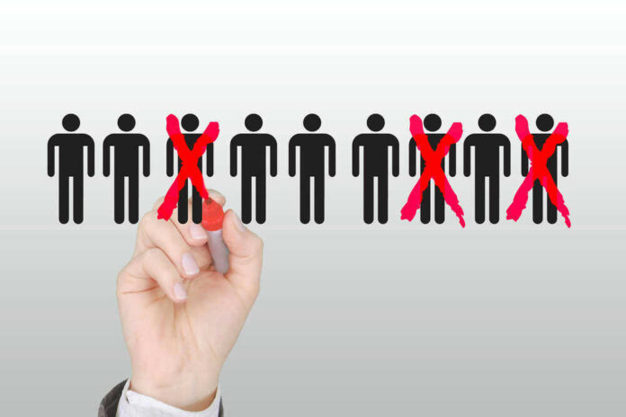 shutterstock_1688476213.jpg Hand crossing out stick figures with a red marker.