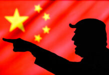 Donald Trump silhouette pointing with Chinese flag background