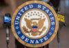 United States Senate seal with microphones in front