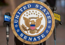 United States Senate seal with microphones in front