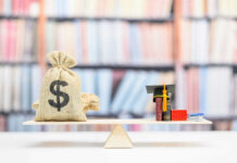 Money bag and books balanced on a seesaw
