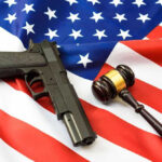 Gun and gavel on a US flag