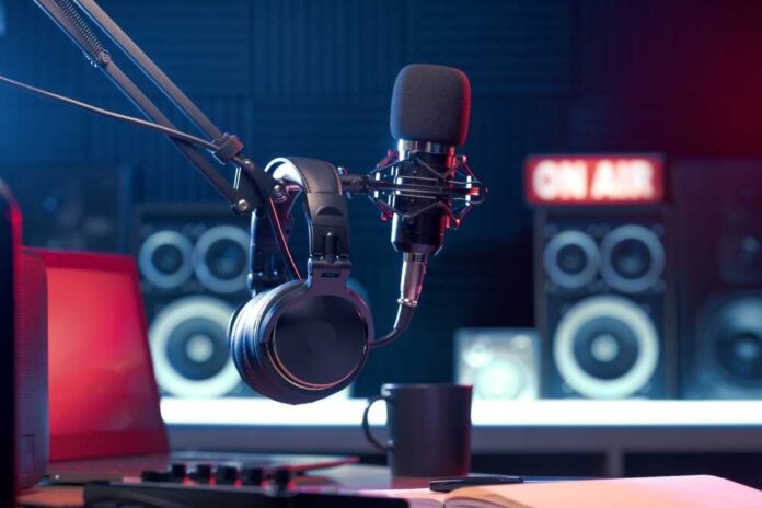 shutterstock_2372976209.jpg Close-up of a microphone and headphones in a podcast studio
