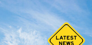 Yellow sign with text Latest News on sky background