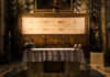Church altar with Shroud of Turin above it