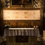 Church altar with Shroud of Turin above it