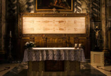 Church altar with Shroud of Turin above it