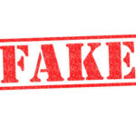 Red stamp with the word FAKE prominently displayed