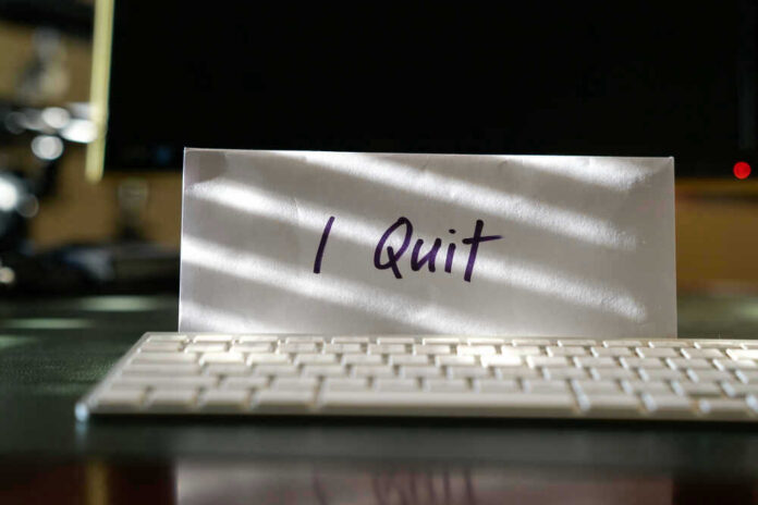 shutterstock_1438530527.jpg Envelope reading I Quit behind keyboard.