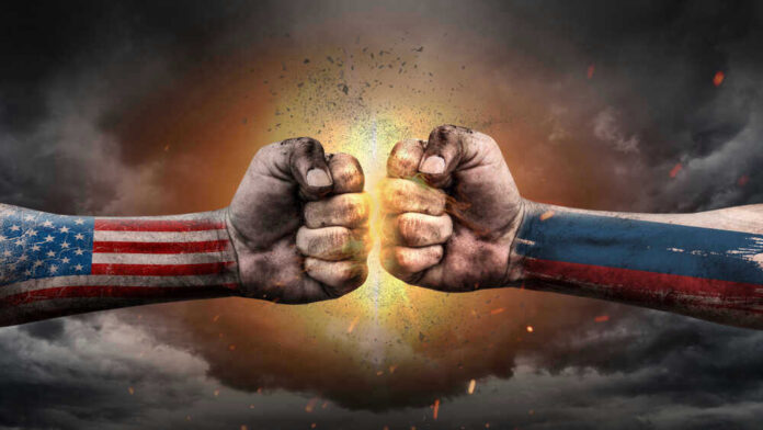shutterstock_1544668523.jpg U.S. and Russian flag fists colliding dramatically.