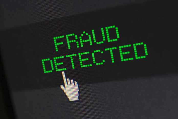 shutterstock_1806836992.jpg Fraud detected text with a pixelated cursor icon.