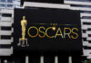 Oscars billboard on a city building exterior wall