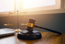 Gavel and scales of justice on desk.