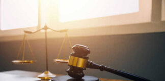 Gavel and scales of justice on desk.