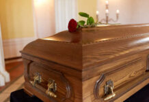 Billionaire’s 50-Year Love Affair ENDS — Wife Dead A wooden casket with a red rose placed on top