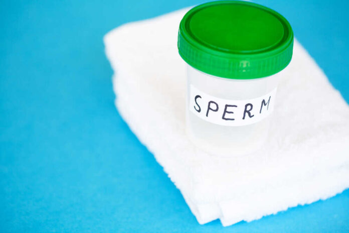 Container labeled 'SPERM' on a white towel against a blue background