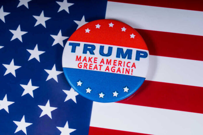 shutterstock_1236975919.jpg Campaign button with Trump, Make America Great Again.