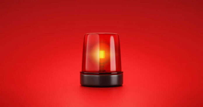 shutterstock_2053758056.jpg Red emergency light on red background