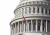 U.S. Capitol dome with American flag flying.