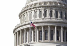 U.S. Capitol dome with American flag flying.