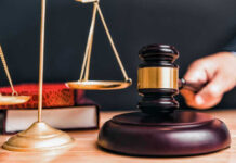 Gang Leader Gets LIFE — Americans Brutalized Judge gavel, scales of justice, and law books.