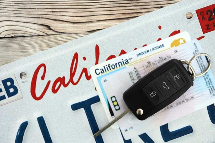 shutterstock_2716335915.jpg California license plate, driver's license, and car keys on a wooden surface