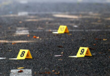 Gunmen EXECUTE 12 Including Three Children Yellow evidence markers labeled 8, 9, 10 on pavement.