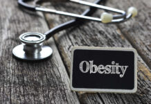 A stethoscope next to a sign that reads 'Obesity'