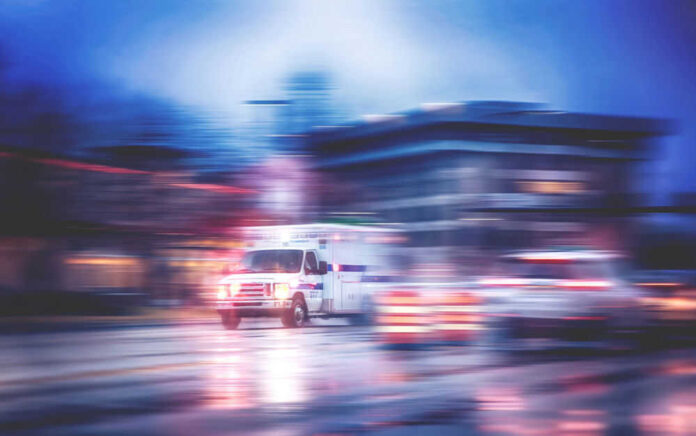 shutterstock_532768414.jpg Ambulance speeding through city street at night